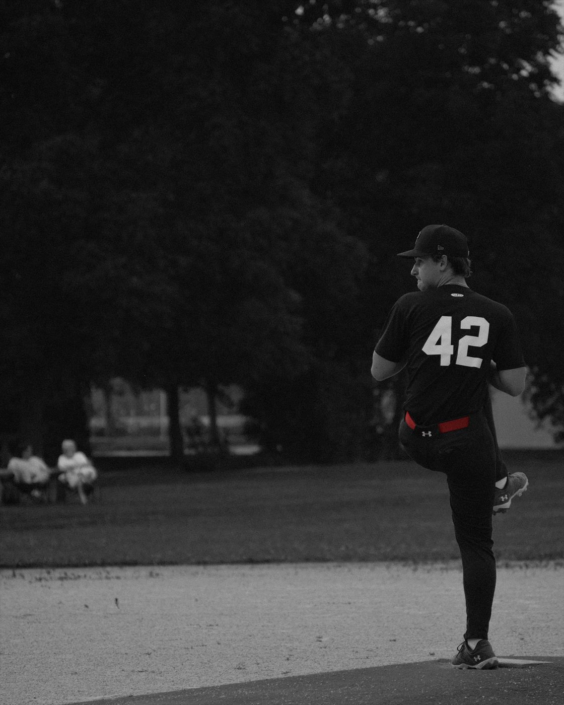 Baseball pitcher on the mound during a game.